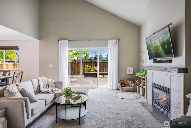 6713 135th E, Puyallup, WA 98373 - living room featuring high vaulted ceiling, carpet, and a tiled fireplace