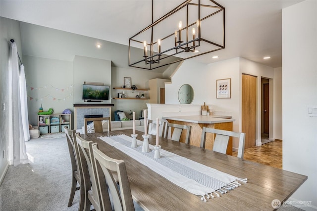 6713 135th E, Puyallup, WA 98373 - carpeted dining space with recessed lighting, a chandelier, and a tiled fireplace