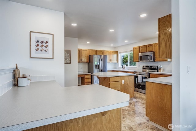 6713 135th E, Puyallup, WA 98373 - kitchen with appliances with stainless steel finishes, recessed lighting, light countertops, and a kitchen island