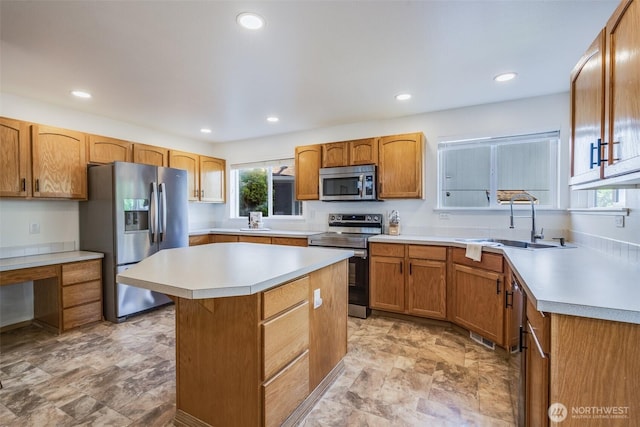 6713 135th E, Puyallup, WA 98373 - kitchen featuring stainless steel appliances, light countertops, plenty of natural light, a center island, and recessed lighting