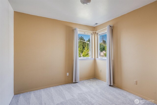6713 135th E, Puyallup, WA 98373 - spare room with light carpet and baseboards