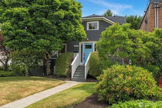 1222 6th Ave N, Seattle, WA 98109 - view of property hidden behind natural elements with a front yard and roof with shingles