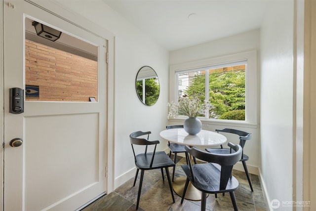 1222 6th Ave N, Seattle, WA 98109 - dining room with healthy amount of natural light and dark stone finish flooring