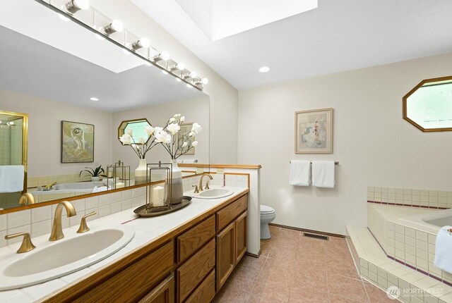 16909 NE 37th Pl, Bellevue, WA 98008 - bathroom featuring double vanity, a bath, backsplash, and tile patterned flooring