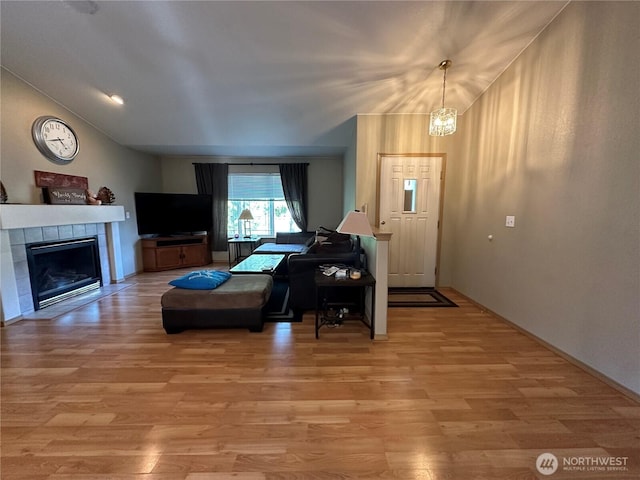 15015 105th Ave SE, Yelm, WA 98597 - living area featuring vaulted ceiling, light wood-style flooring, and a tile fireplace