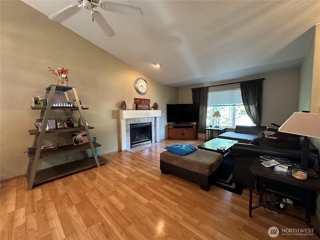 15015 105th Ave SE, Yelm, WA 98597 - living area with lofted ceiling, a fireplace, light wood-type flooring, and a ceiling fan