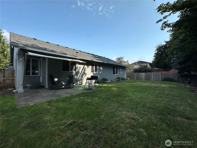 15015 105th Ave SE, Yelm, WA 98597 - rear view of property featuring a fenced backyard, a patio, and a shingled roof
