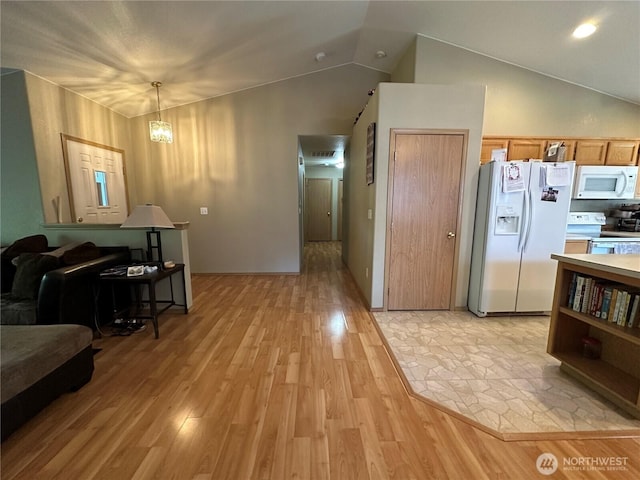 15015 105th Ave SE, Yelm, WA 98597 - kitchen with white appliances, light wood-type flooring, lofted ceiling, light countertops, and decorative light fixtures