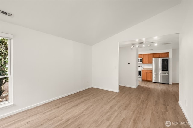 1116 30th St NE, Auburn, WA 98002 - unfurnished living room with light wood-style flooring, vaulted ceiling, and track lighting