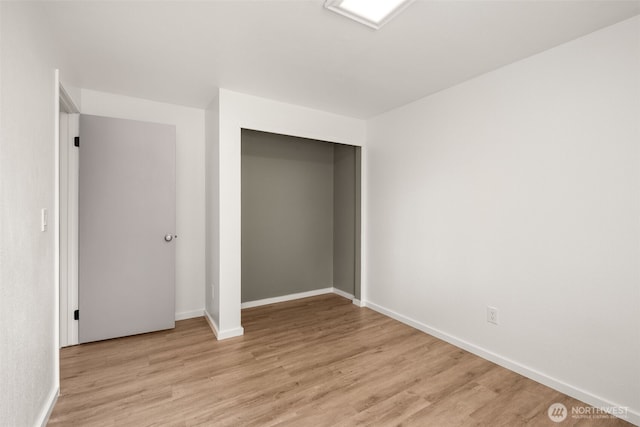1116 30th St NE, Auburn, WA 98002 - unfurnished bedroom featuring light wood-style floors and a closet