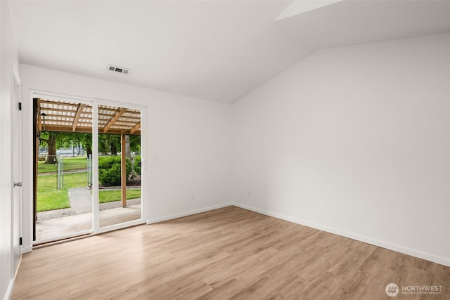 1116 30th St NE, Auburn, WA 98002 - empty room with light wood finished floors and vaulted ceiling