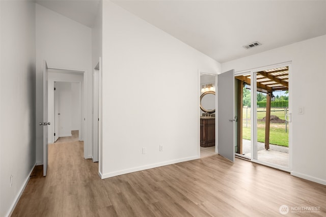 1116 30th St NE, Auburn, WA 98002 - empty room with light wood-style floors and vaulted ceiling