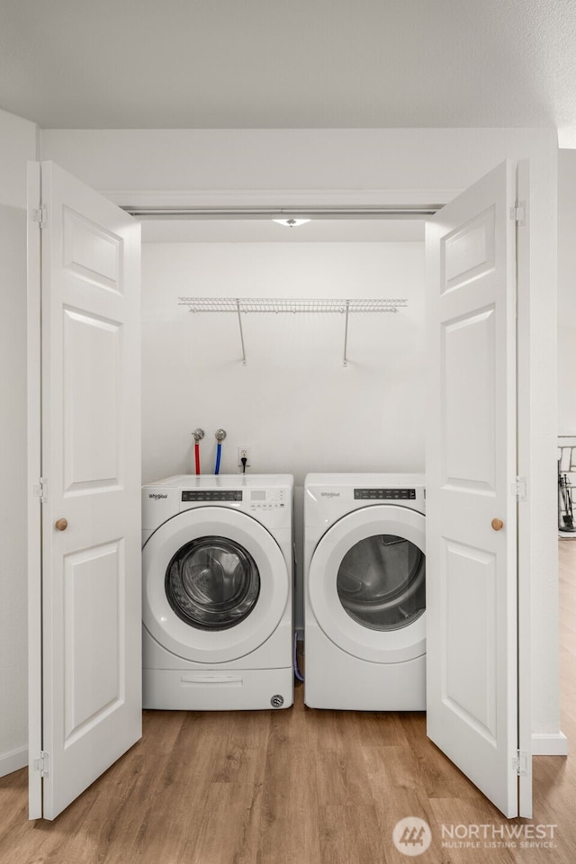 1116 30th St NE, Auburn, WA 98002 - laundry area featuring wood finished floors and washing machine and clothes dryer