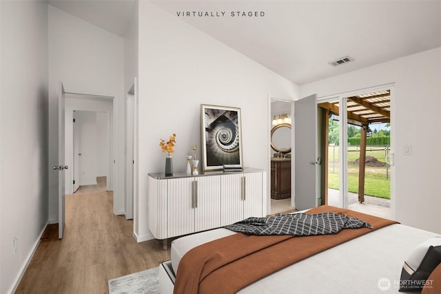 1116 30th St NE, Auburn, WA 98002 - bedroom with access to exterior, light wood-type flooring, high vaulted ceiling, and connected bathroom