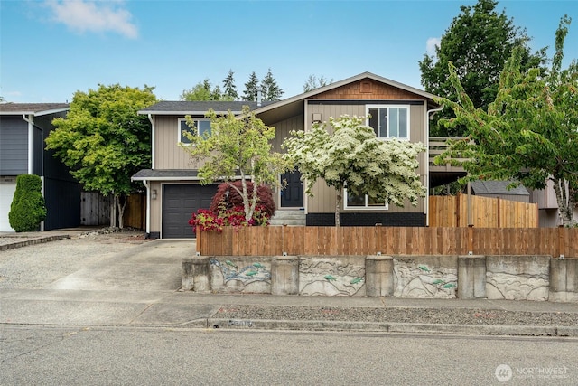3918 Commencement Bay Dr, Tacoma, WA 98407 - view of front facade featuring a fenced front yard, concrete driveway, and an attached garage
