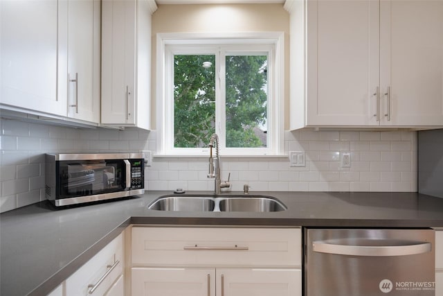 3918 Commencement Bay Dr, Tacoma, WA 98407 - kitchen featuring stainless steel appliances, dark countertops, white cabinets, and backsplash