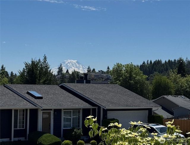 3918 Commencement Bay Dr, Tacoma, WA 98407 - single story home with a shingled roof, a garage, and a mountain view