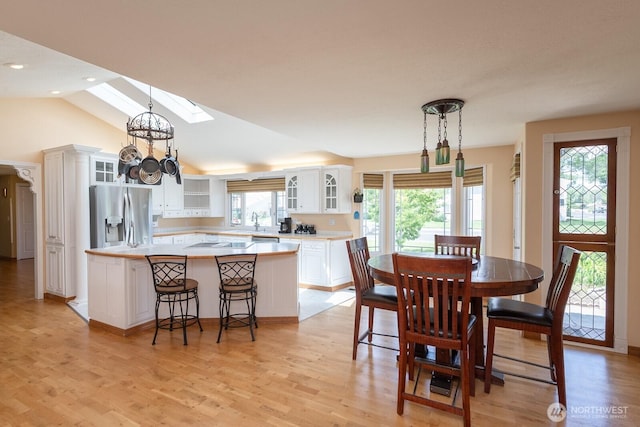 350 E Division Ave, Ephrata, WA 98823 - dining space featuring a skylight, light wood-style flooring, vaulted ceiling, and recessed lighting