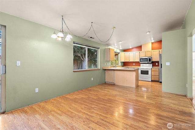 3117 243rd Street Ct E, Spanaway, WA 98387 - kitchen with stainless steel appliances, light wood-style floors, a peninsula, a chandelier, and lofted ceiling