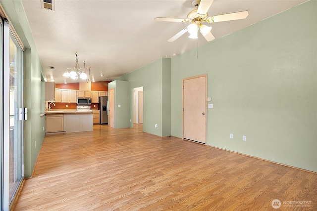 3117 243rd Street Ct E, Spanaway, WA 98387 - unfurnished living room featuring light wood-style floors, ceiling fan, and a chandelier