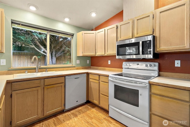 3117 243rd Street Ct E, Spanaway, WA 98387 - kitchen with white appliances, light countertops, light wood finished floors, light brown cabinets, and vaulted ceiling