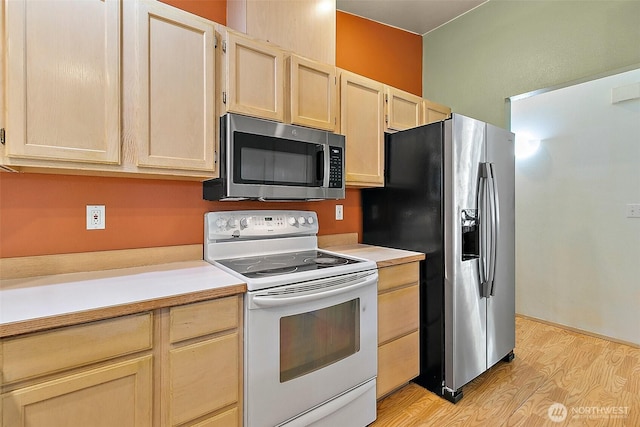 3117 243rd Street Ct E, Spanaway, WA 98387 - kitchen with stainless steel appliances, light brown cabinetry, light countertops, and light wood-type flooring