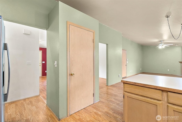 3117 243rd Street Ct E, Spanaway, WA 98387 - kitchen with a ceiling fan, light wood-style floors, and light brown cabinets