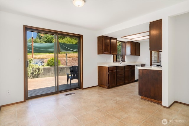 18552 15th Loop NE, Poulsbo, WA 98370 - kitchen featuring light countertops, white dishwasher, and dark brown cabinetry