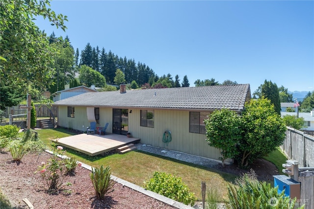 18552 15th Loop NE, Poulsbo, WA 98370 - back of property with a wooden deck, a tile roof, and a chimney