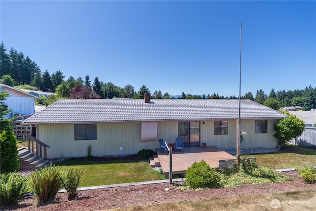 18552 15th Loop NE, Poulsbo, WA 98370 - rear view of property featuring a tiled roof, a lawn, a chimney, and a wooden deck