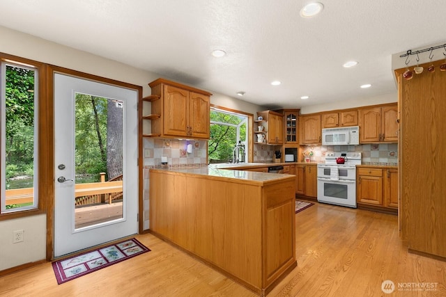 44520 SE 144th St, North Bend, WA 98045 - kitchen featuring white appliances, open shelves, a peninsula, light wood-style flooring, and brown cabinets