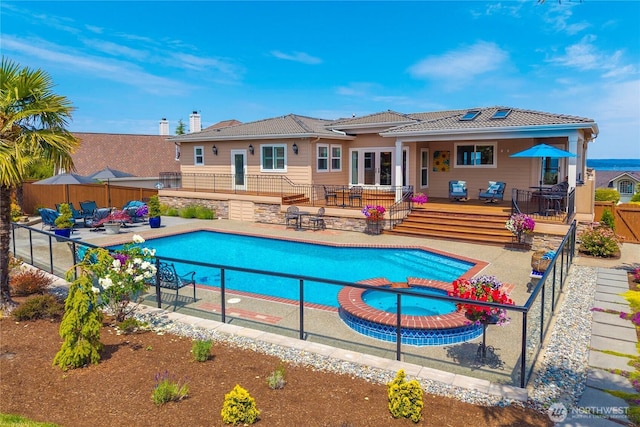 2014 Parkview Dr NE, Tacoma, WA 98422 - view of swimming pool featuring a deck, a pool with connected hot tub, a patio area, and outdoor dining space