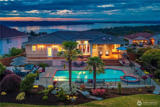2014 Parkview Dr NE, Tacoma, WA 98422 - back of house at dusk featuring a tile roof and a fenced backyard