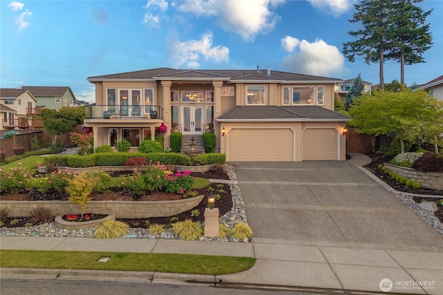2014 Parkview Dr NE, Tacoma, WA 98422 - view of front of home with french doors, a garage, a balcony, driveway, and a tiled roof