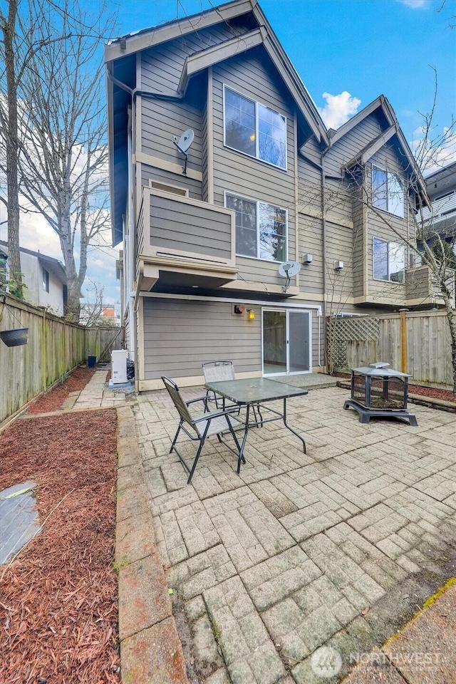8614 23rd Ave NE Unit A, Seattle, WA 98115 - rear view of house with a patio and a fenced backyard