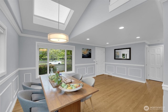 8410 9th Ave SW, Seattle, WA 98106 - dining area with a decorative wall, a skylight, a wainscoted wall, light wood finished floors, and recessed lighting