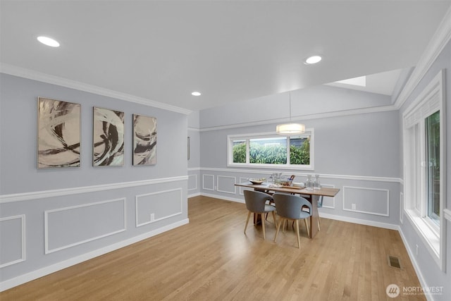 8410 9th Ave SW, Seattle, WA 98106 - dining room featuring a decorative wall, wood finished floors, crown molding, and a wainscoted wall