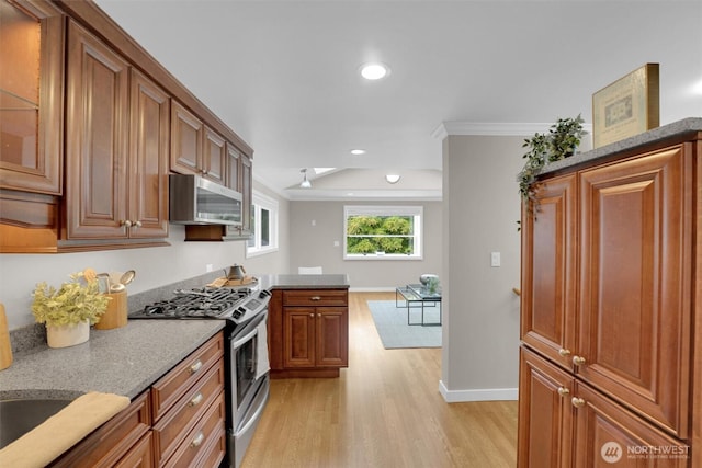 8410 9th Ave SW, Seattle, WA 98106 - kitchen with appliances with stainless steel finishes, light wood-type flooring, brown cabinetry, ornamental molding, and recessed lighting