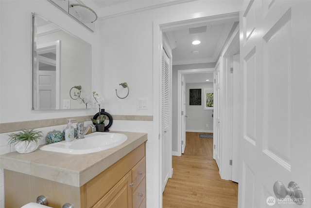8410 9th Ave SW, Seattle, WA 98106 - bathroom featuring vanity, ornamental molding, and wood finished floors