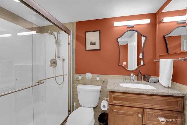 8410 9th Ave SW, Seattle, WA 98106 - bathroom featuring vanity, a stall shower, tile walls, and a wainscoted wall
