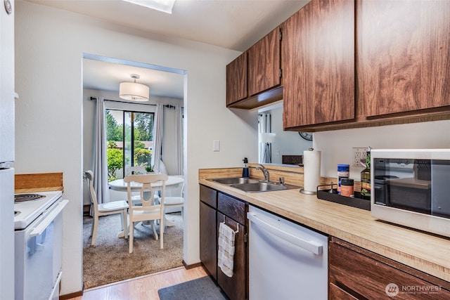1102 8th St NE Unit 22, Auburn, WA 98002 - kitchen with white appliances, light countertops, and light wood finished floors