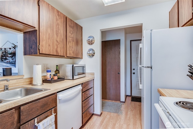 1102 8th St NE Unit 22, Auburn, WA 98002 - kitchen with white appliances, light countertops, light wood-style flooring, and brown cabinets