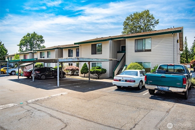 1102 8th St NE Unit 22, Auburn, WA 98002 - view of building exterior featuring covered and uncovered parking and stairway