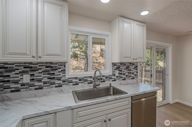 2117 S Majestic Dr, East Wenatchee, WA 98802 - kitchen featuring stainless steel dishwasher, light wood-style floors, white cabinets, decorative backsplash, and recessed lighting