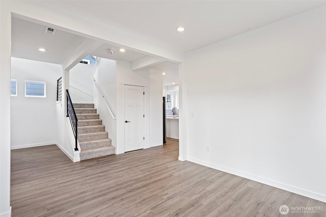 7812 S Sheridan Ave, Tacoma, WA 98408 - unfurnished living room featuring wood finished floors, stairway, and recessed lighting