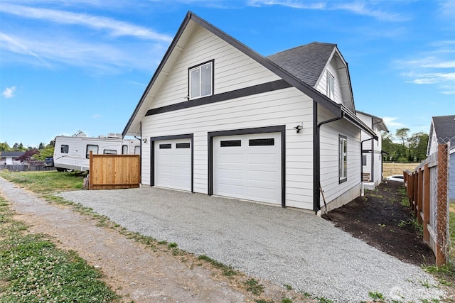 7812 S Sheridan Ave, Tacoma, WA 98408 - view of property exterior with driveway, a garage, and roof with shingles