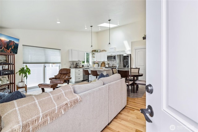 410 Eddy Ct, Port Townsend, WA 98368 - living area with high vaulted ceiling, light wood finished floors, and recessed lighting