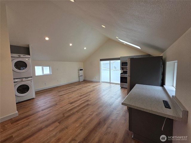 410 Eddy Ct, Port Townsend, WA 98368 - bonus room with stacked washing machine and dryer, lofted ceiling, wood finished floors, recessed lighting, and a textured ceiling