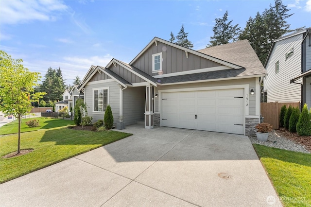 16712 8th Ave E, Spanaway, WA 98387 - craftsman-style house with board and batten siding, driveway, stone siding, and a shingled roof