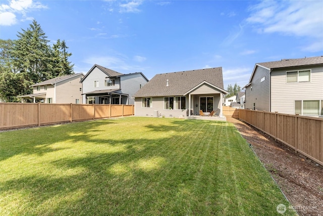 16712 8th Ave E, Spanaway, WA 98387 - back of house with a fenced backyard, a patio, roof with shingles, and a residential view